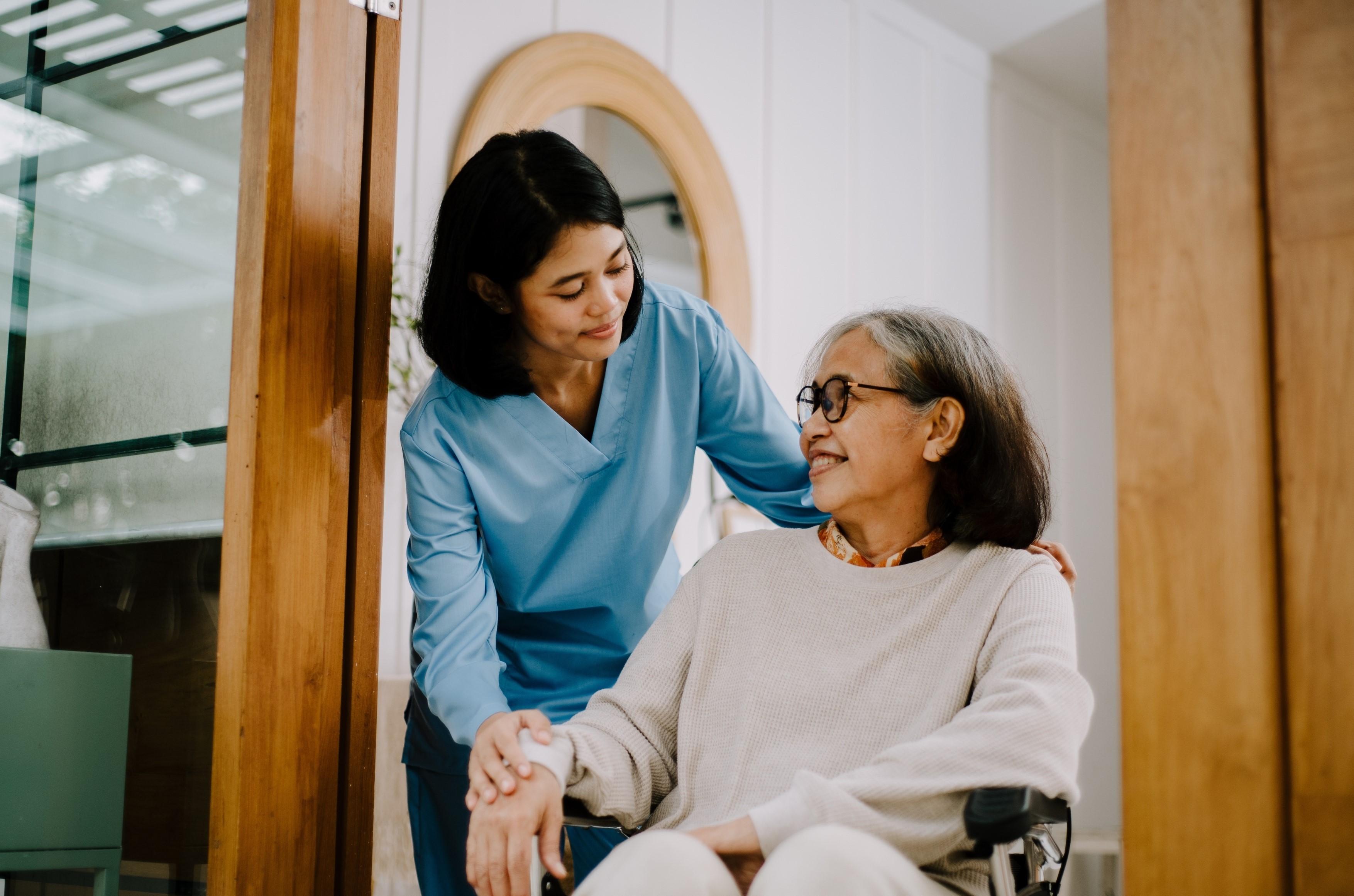 Compassionate Divine Consulting nurse providing care to an elderly client at home